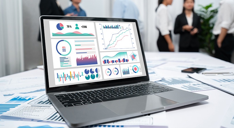 A laptop screen displaying graphs and data.